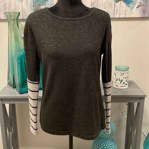 Charcoal grey fleece sweater with light grey striped sleeves.